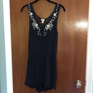 Navy romper with white flowers detail